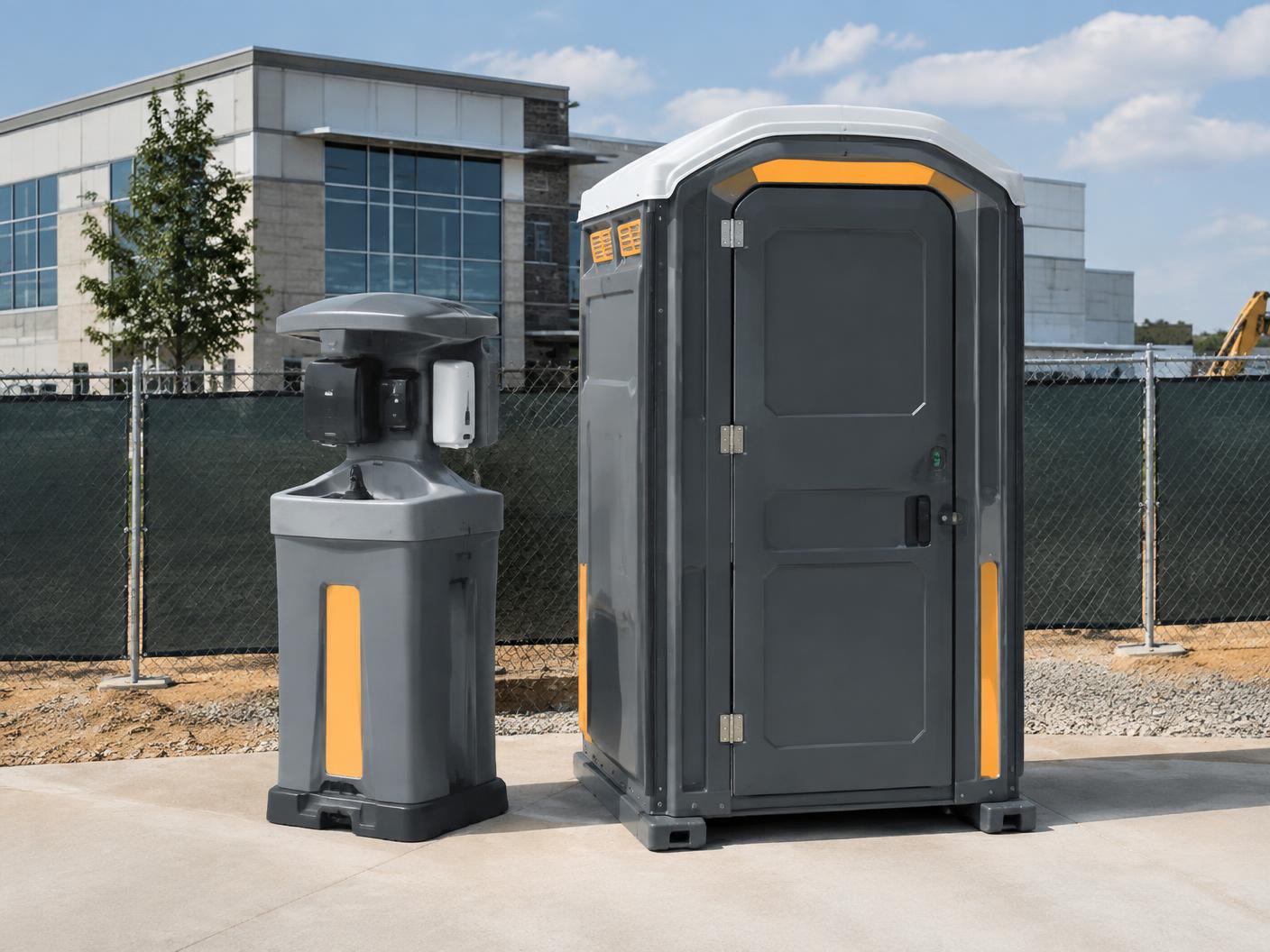 Clean modern portable restroom and handwashing station at a commercial jobsite